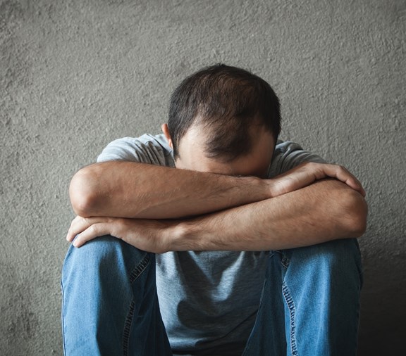 Caucasian depressed man. Mental health resources needed ASAP