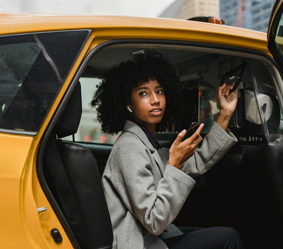 Young woman getting out of a car