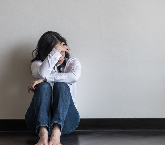 Domestic violence awareness - woman hiding in fear