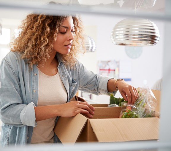 Stocking fridge with groceries